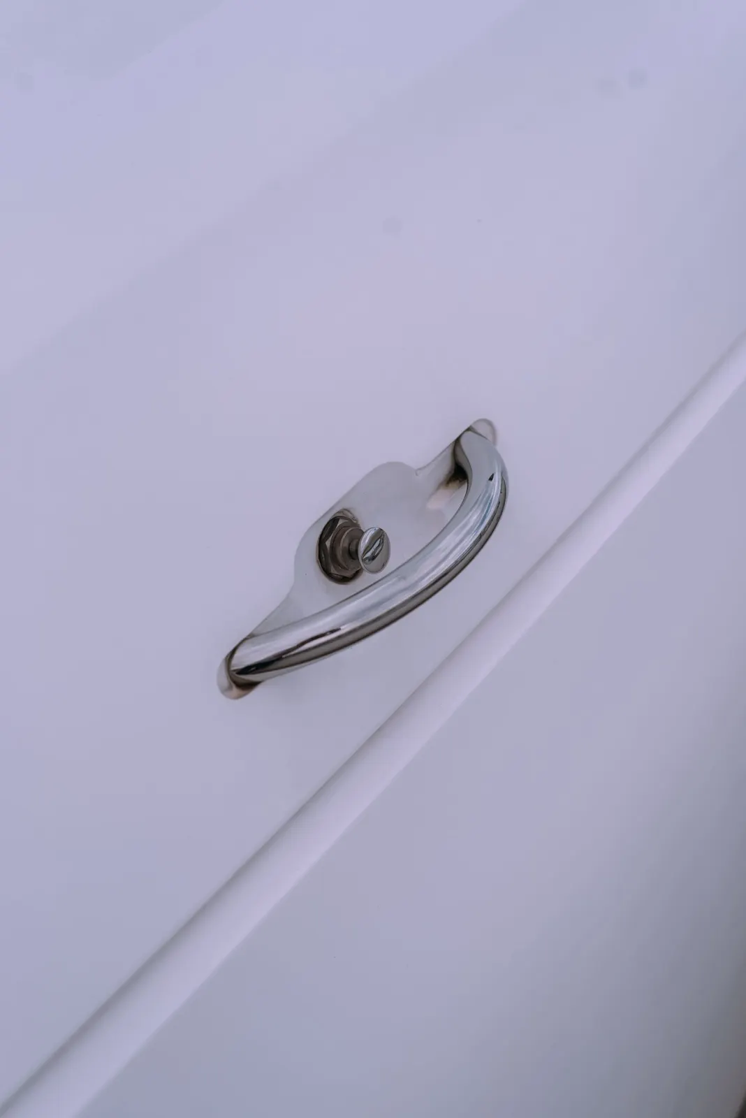 Cabinet handle on a white shutter