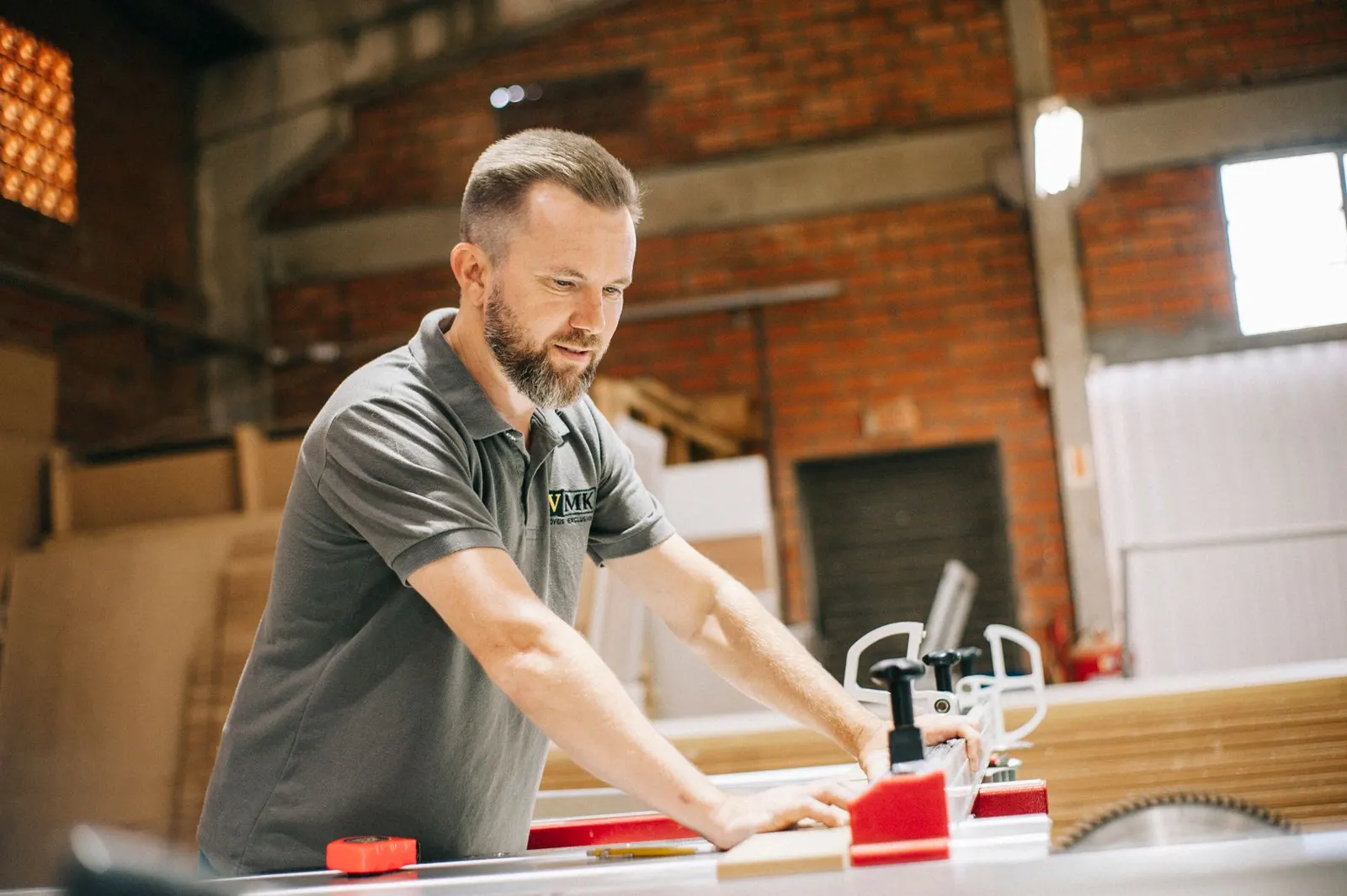 Carpenter cutting a board in the workshop