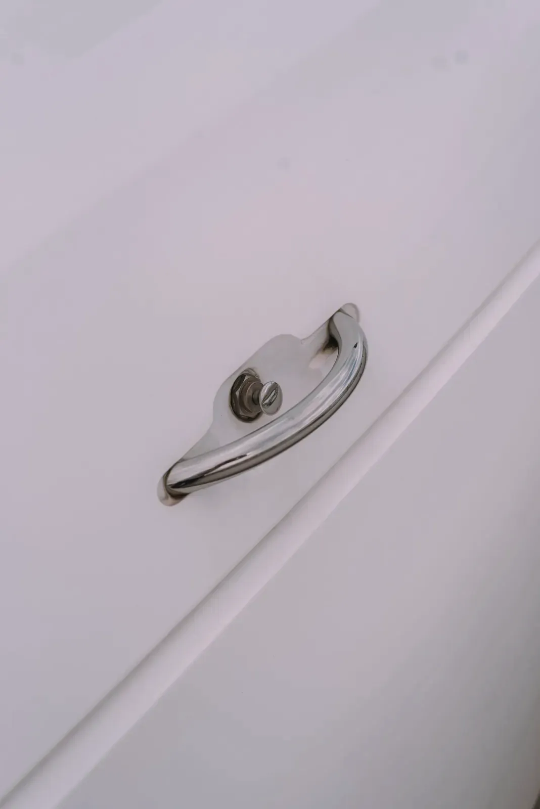 Cabinet handle on a white shutter