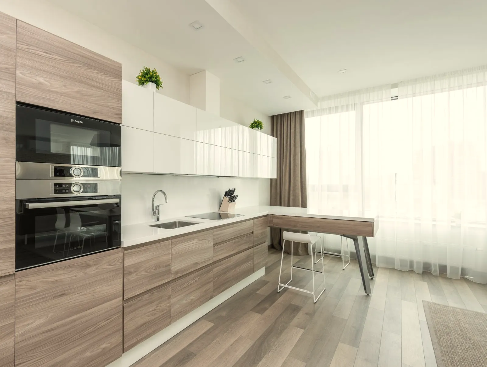 Oak and white kitchen with an attached breakfast peninsula