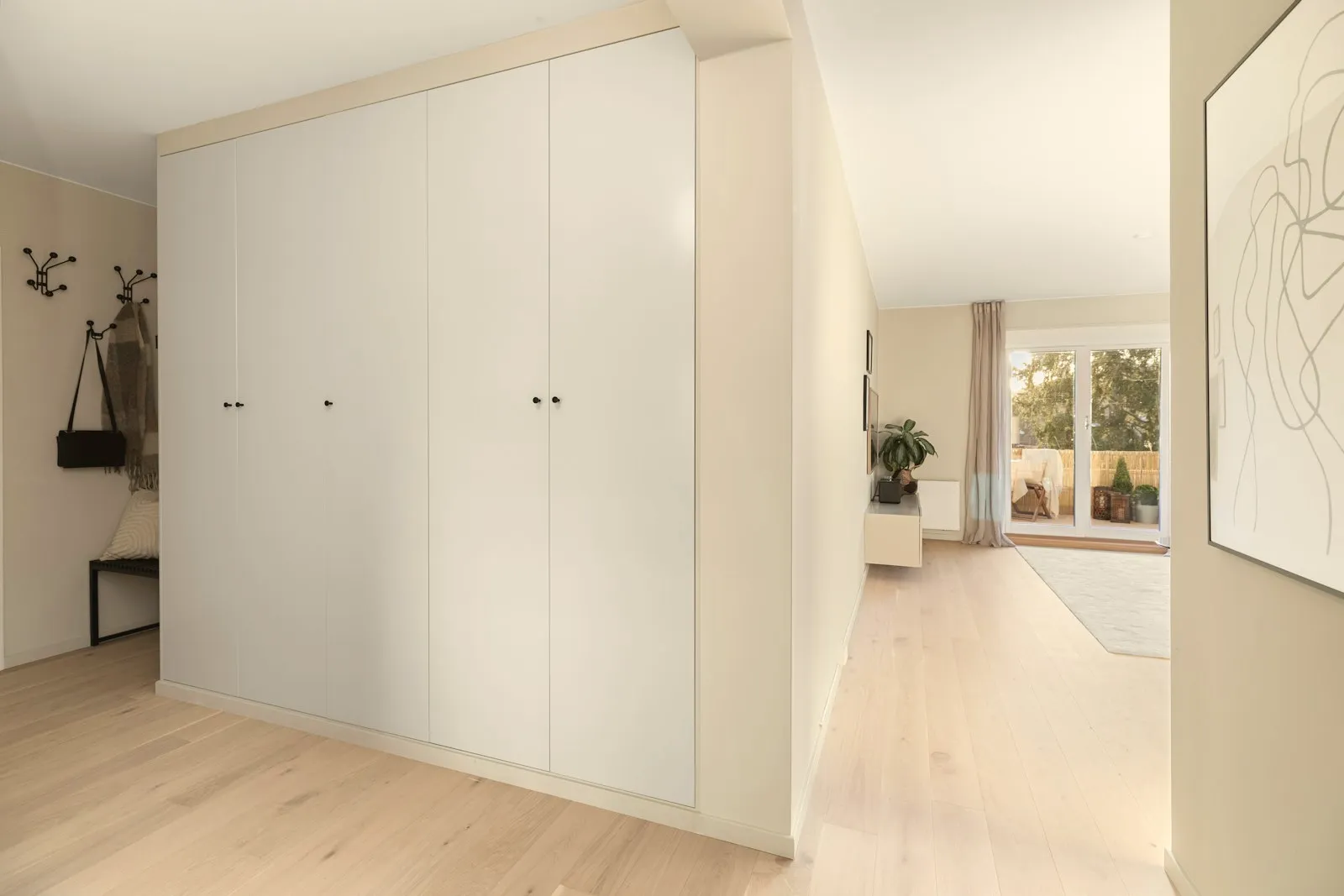 Floor-to-ceiling white handleless wardrobe